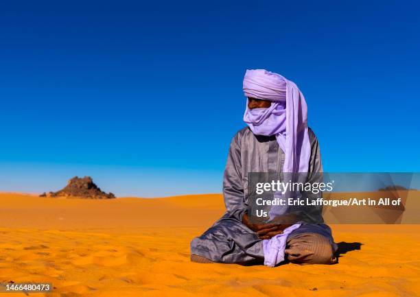 Tuareg sit in the Sahara desert, North Africa, Erg Admer, Algeria on January 2, 2023 in Erg Admer, Algeria.