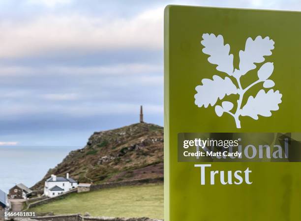 The National Trust logo is seen on a a sign at the entrance to the National Trust owner car park at Cape Cornwall on February 11, 2023 in Cornwall,...