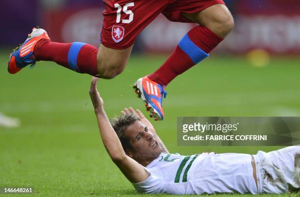 Portuguese defender Fabio Coentrao vies with Czech forward Milan Baros during the Euro 2012 football championships quarter-final match between the...