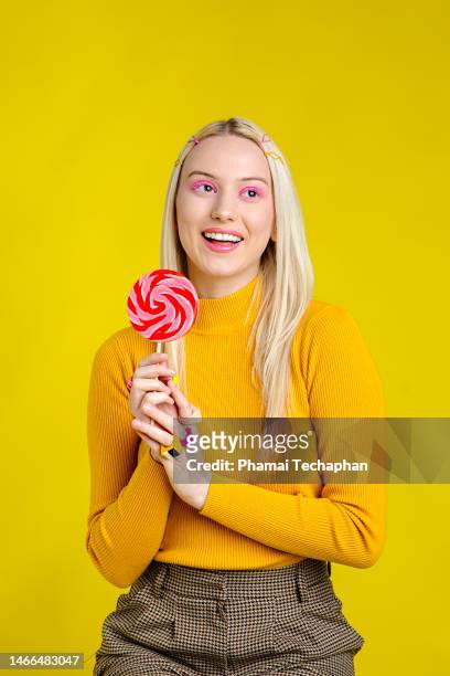 woman holding a large lollipop - lolly models stockfoto's en -beelden