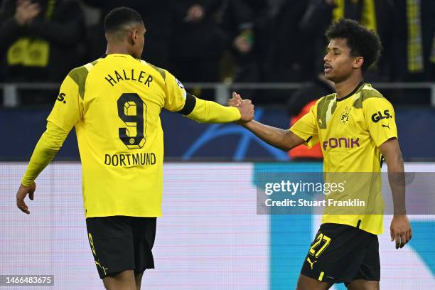 Karim Adeyemi (Rof Borussia Dortmund celebrates with teammate after scoring the team's first goal during the UEFA Champions League round of 16 leg...