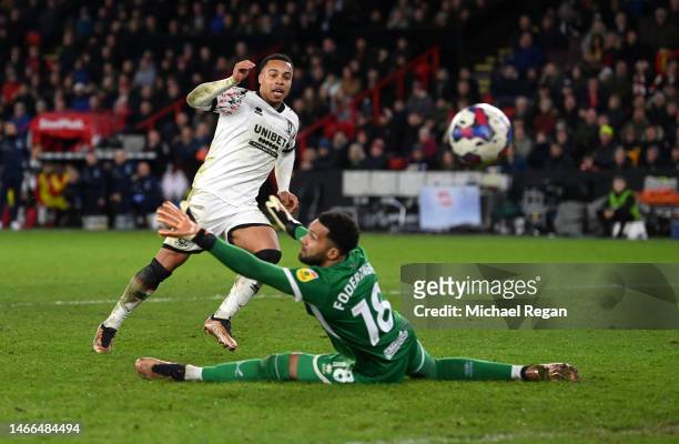 Cameron Archer of Middlesbrough scores the team's third goal past Wes Foderingham of Sheffield United during the Sky Bet Championship between...