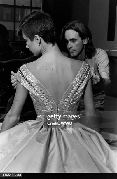 Designer Ossie Clark fits a model