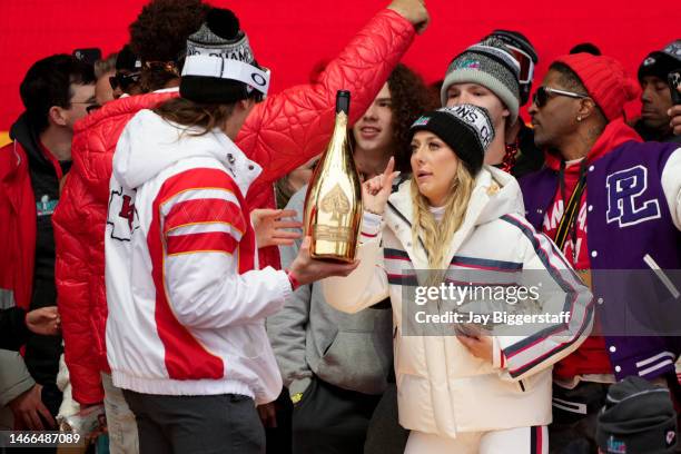 Tommy Townsend of the Kansas City Chiefs and Brittany Mahomes celebrate on stage during the Kansas City Chiefs Super Bowl LVII victory parade on...