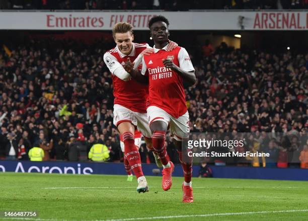 Bukayo Saka celebrates scoring the Arsenal goal with Martin Odegaard during the Premier League match between Arsenal FC and Manchester City at...