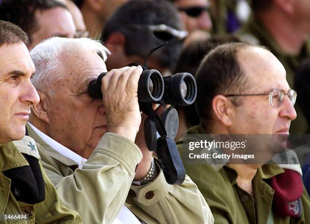 Israeli Prime Minister Ariel Sharon , Army Chief of Staff Lieutenant General Moshe Yaalon and Major General Iftah Ron-Tal, watch an army exercise...