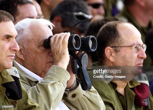 Israeli Prime Minister Ariel Sharon , Army Chief of Staff Lieutenant General Moshe Yaalon and Major General Iftah Ron-Tal, watch an army exercise...