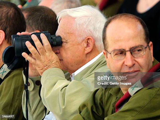 Israeli Prime Minister Ariel Sharon and Army Chief of Staff Lt. Gen. Moshe Yaalon watch an army exercise during a visit to Shizafon army base October...