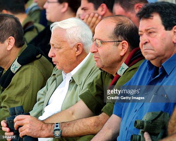 Israeli Prime Minister Ariel Sharon , Army Chief of Staff Lieutenant General Moshe Yaalon and Defense Minister Binyamin Ben Eliezer watch an army...