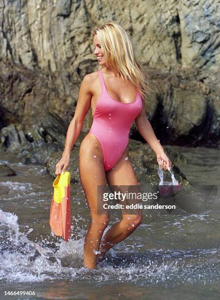 Actress Pamela Anderson poses for a portrait wearing swimsuit on Catalina Island,California during filming of TV series Baywatch in October 1992.
