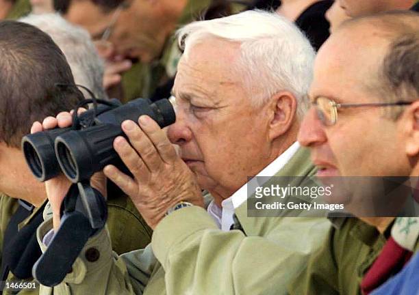 Israeli Prime Minister Ariel Sharon and Army Chief of Staff Lieutenant General Moshe Yaalon watch an army exercise during a visit to Shizafon army...