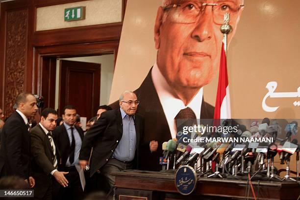 Egypt's presidential candidate Ahmed Shafiq, the last premier of ousted Egyptian strongman Hosni Mubarak, arrives for a press conference in Cairo, on...