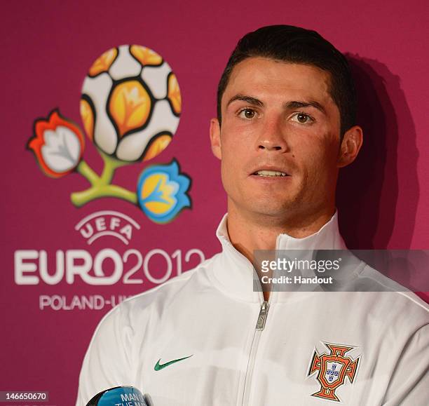 In this handout image provided by UEFA, Cristiano Ronaldo of Portugal receives the man of the match award after the UEFA EURO 2012 Quarter Final...