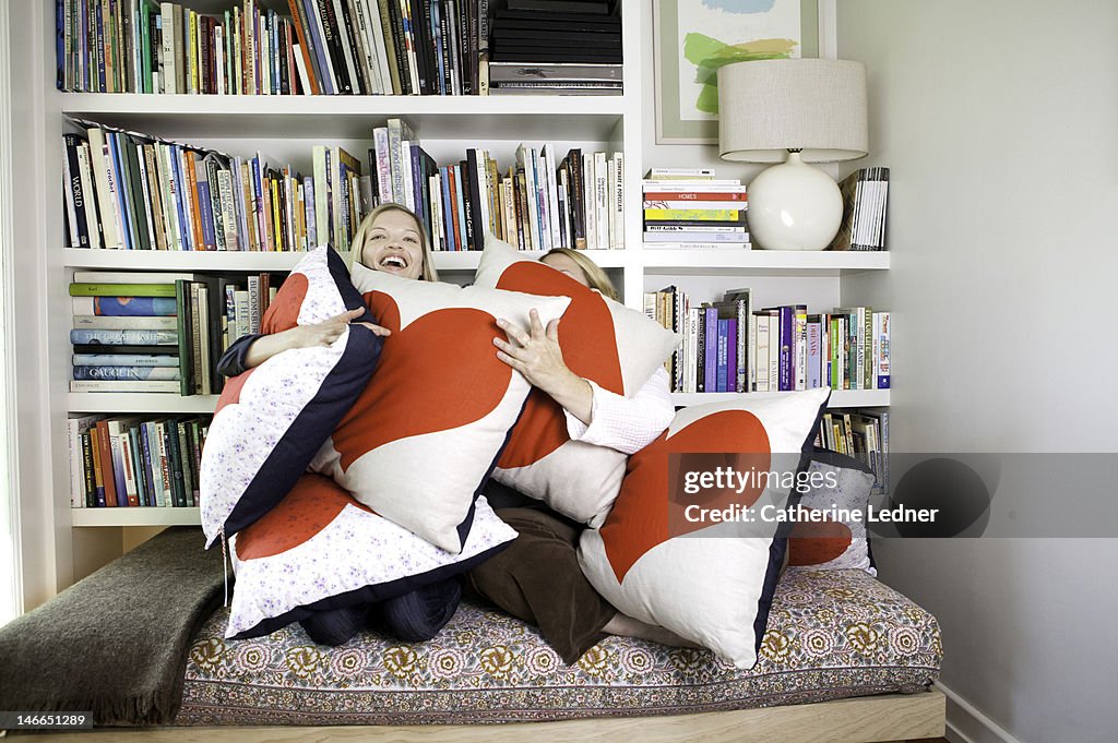 Two Women Hugging Heat Shaped Pillows