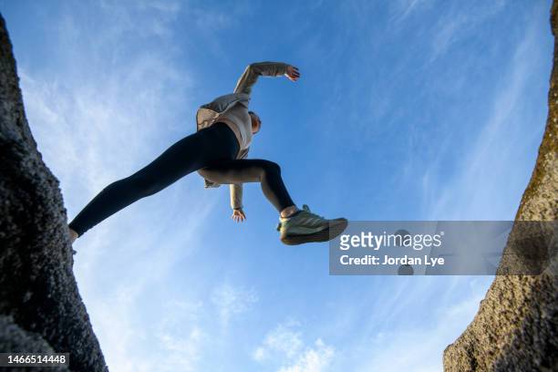 low angle jump across - leap forward stock pictures, royalty-free photos & images