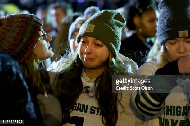 Students, faculty and others in the community attend a vigil on the campus of Michigan State University following Monday's shooting on February 15,...