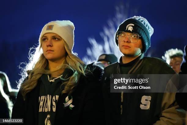 Students, faculty and others in the community attend a vigil on the campus of Michigan State University following Monday's shooting on February 15,...