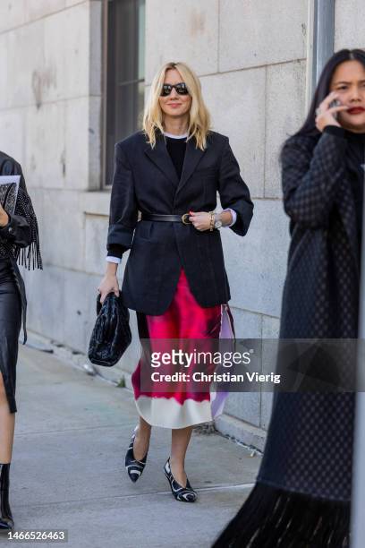 Lisa Aiken wears black belted blazer, red white skirt with print, black Bottega Veneta bag outside Gabriela Hearst during New York Fashion Week on...