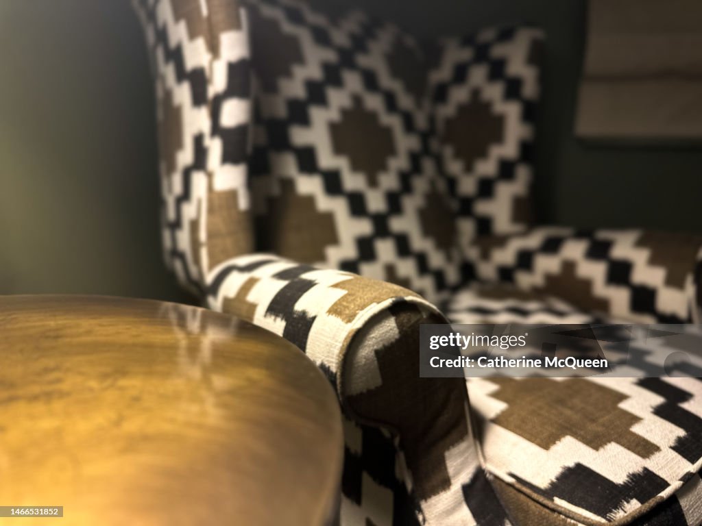 Traditional high back wingback chair with bold print fabric & side table