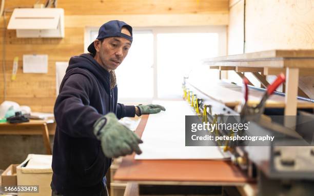 a man making hand made snowboards at his workshop - moulding a shape stock pictures, royalty-free photos & images