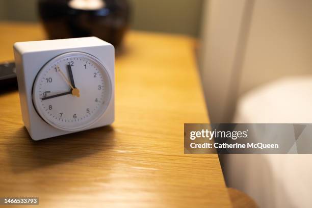 alarm clock on bedside table - daylight savings stock pictures, royalty-free photos & images