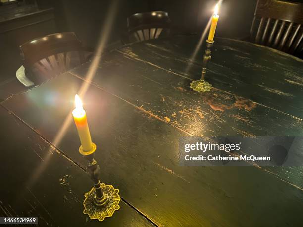 candlelight setting on antique table - dining table stock pictures, royalty-free photos & images