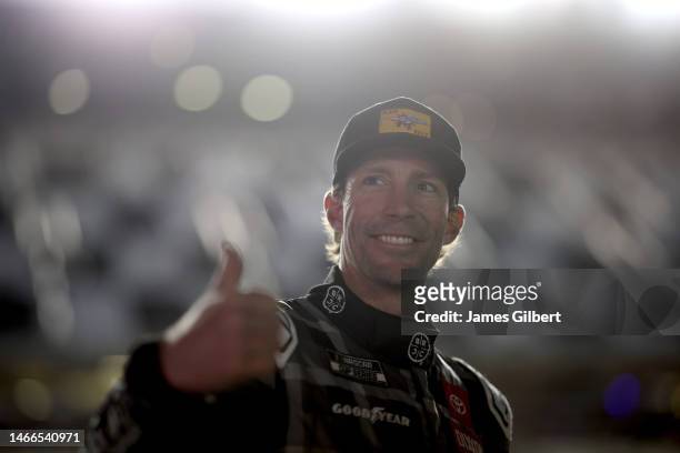 Travis Pastrana, driver of the Black Rifle Coffee Toyota, gives a thumbs up on the grid during qualifying for the Busch Light Pole at Daytona...