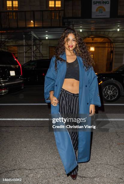 Yendry wears blue coat, black white striped pants, cropped top outside Willy Chavarria New York Fashion Week during on February 15, 2023 in New York...