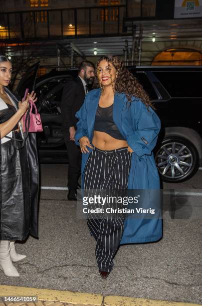 Yendry wears blue coat, black white striped pants, cropped top outside Willy Chavarria New York Fashion Week during on February 15, 2023 in New York...