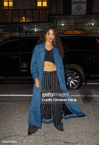 Yendry wears blue coat, black white striped pants, cropped top outside Willy Chavarria New York Fashion Week during on February 15, 2023 in New York...