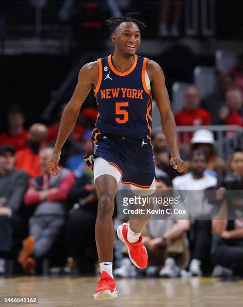 Immanuel Quickley of the New York Knicks reacts after a three-point basket against the Atlanta Hawks during the fourth quarter at State Farm Arena on...