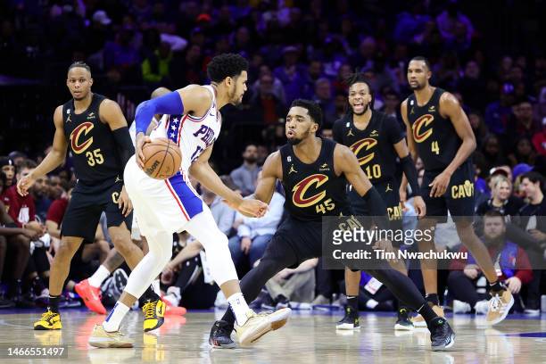 Donovan Mitchell of the Cleveland Cavaliers guards Tobias Harris of the Philadelphia 76ers during the third quarter at Wells Fargo Center on February...