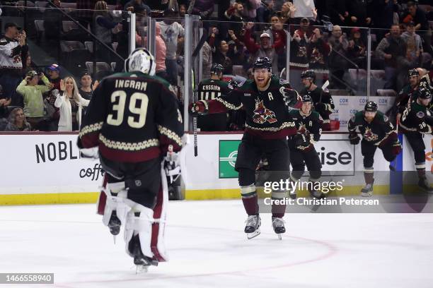 Lawson Crouse of the Arizona Coyotes celebrates with goaltender Connor Ingram after defeating the Tampa Bay Lightning in the NHL game at Mullett...