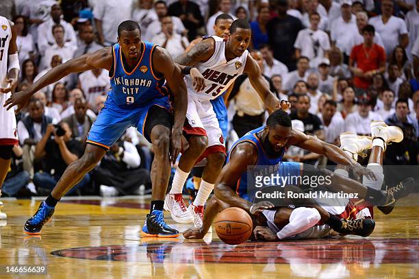 Dwyane Wade and Mario Chalmers of the Miami Heat chase down a loose ball in the first half against James Harden and Serge Ibaka of the Oklahoma City...