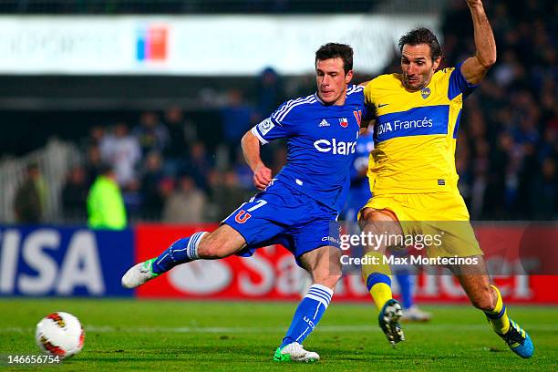 Angelo Henriquez, of Universidad de Chile, fights for the ball with Rolando Schiavi, of Boca Juniors, during the second leg of the Libertadores Cup...