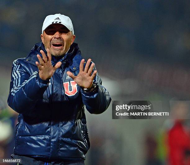 The coach of Chile's team Universidad de Chile, Jorge Sampaoli, gives instructions to his players during the Libertadores Cup second leg semifinal...