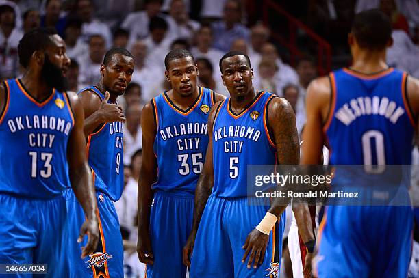 James Harden, Serge Ibaka, Kevin Durant, Kendrick Perkins and Russell Westbrook of the Oklahoma City Thunder stand on court against the Miami Heat in...