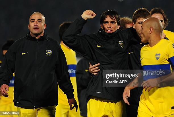 Footballers of Argentina's team Boca Juniors celebrate at the end of the Libertadores Cup second leg semifinal match against Chile's Universidad de...