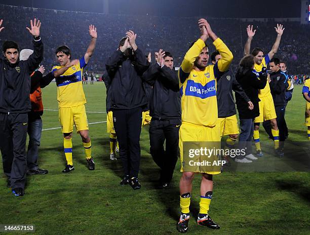 Footballers of Argentina's team Boca Juniors acknowledge their supporters at the end of the Libertadores Cup second leg semifinal match against...