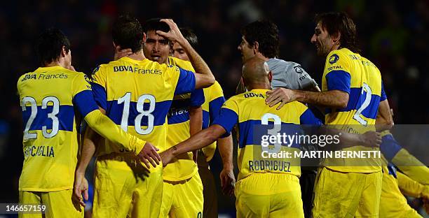 Footballers of Argentina's team Boca Juniors celebrate at the end of the Libertadores Cup second leg semifinal match against Chile's Universidad de...