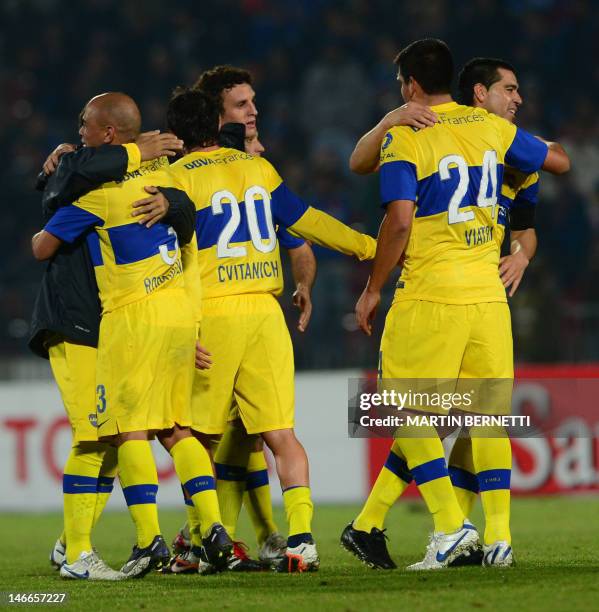 Footballers of Argentina's team Boca Juniors celebrate at the end of the Libertadores Cup second leg semifinal match against Chile's Universidad de...