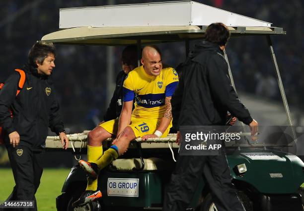 Footballer Santiago Silva of Argentina's team Boca Juniors is assisted during the Libertadores Cup second leg semifinal match against Chile's team...