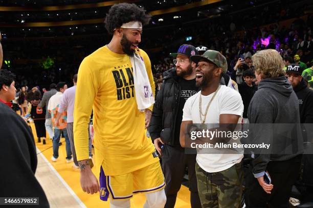Anthony Davis of the Los Angeles Lakers talks to Floyd Mayweather Jr. After a basketball game between the Los Angeles Lakers and the New Orleans...