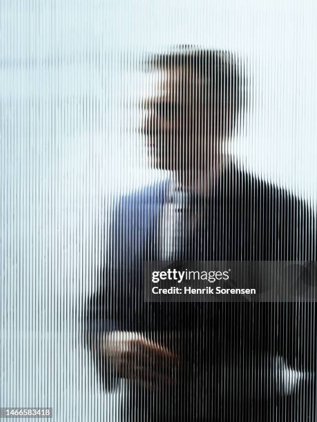 businessman behind glass - person looking through window stock pictures, royalty-free photos & images