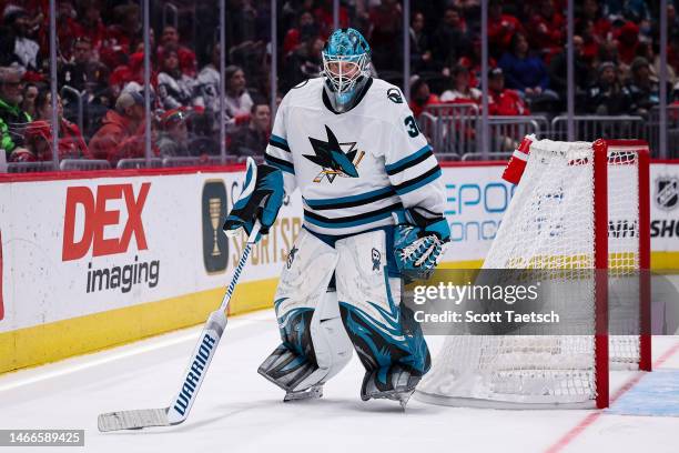 Aaron Dell of the San Jose Sharks handles the puck behind the net during the second period of the game against the Washington Capitals at Capital One...