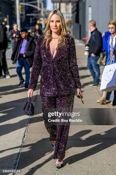 Woman wears a sparkly purple pantsuit at Spring Studios during New York Fashion Week February 2023 on February 15, 2023 in New York City.