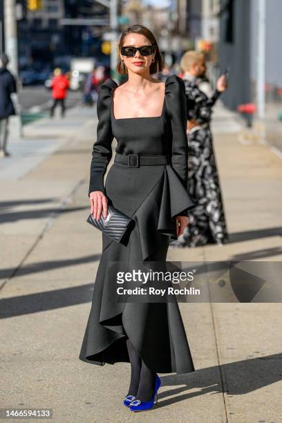 Marina Ingvarsson wears a black gown with a matching purse at Spring Studios during New York Fashion Week February 2023 on February 15, 2023 in New...