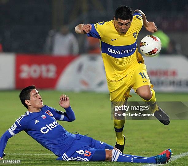 Matias Rodriguez , of Universidad de Chile, fights for the ball with Juan Riquelme , of Boca Juniors, during the second leg of the Libertadores Cup...