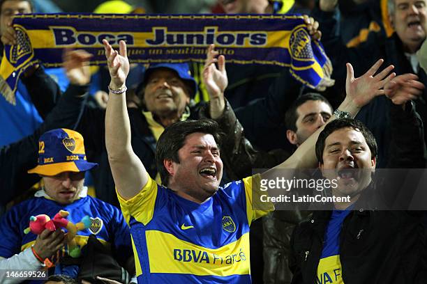 Fans of Boca Juniors cheer for their team during the second leg of the Libertadores Cup 2012 semifinals between Universidad de Chile and Boca Juniors...
