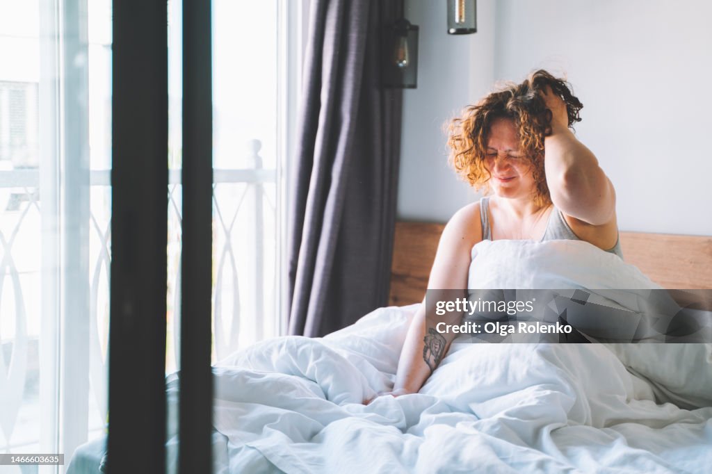 Hangover. Woman feel headache after party in the morning.